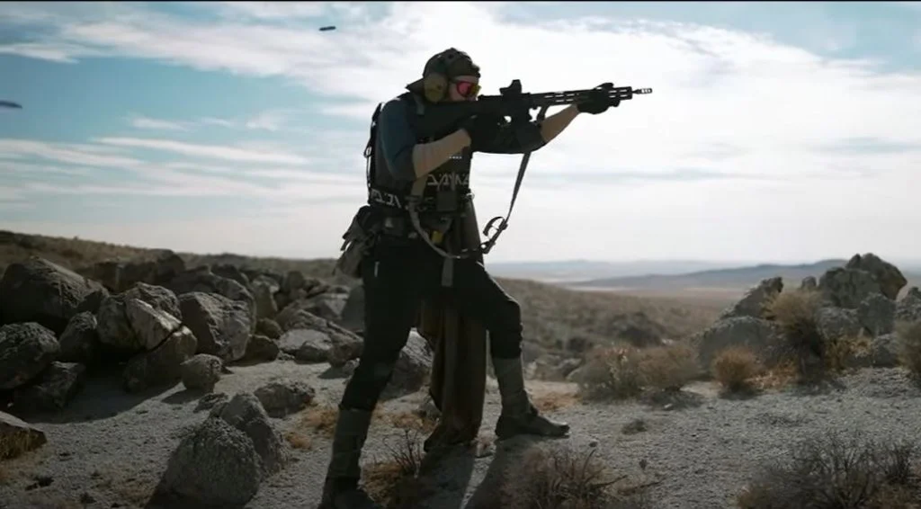 A soldier shooting in filed, wearing ballistic plate